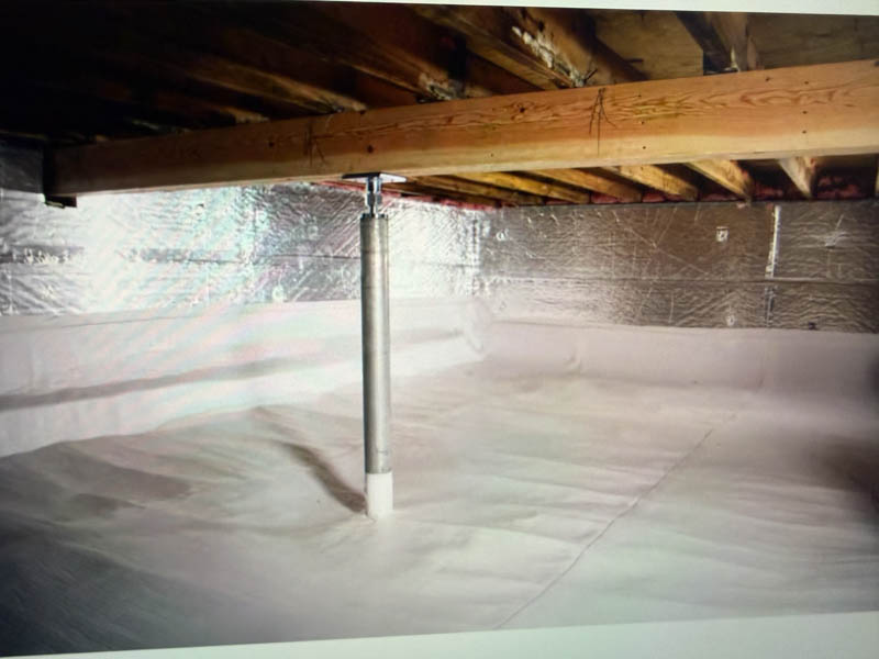 An image of a crawl space with bracers and encapsulation with clean white vapor barrier, wrapped neatly around the posts